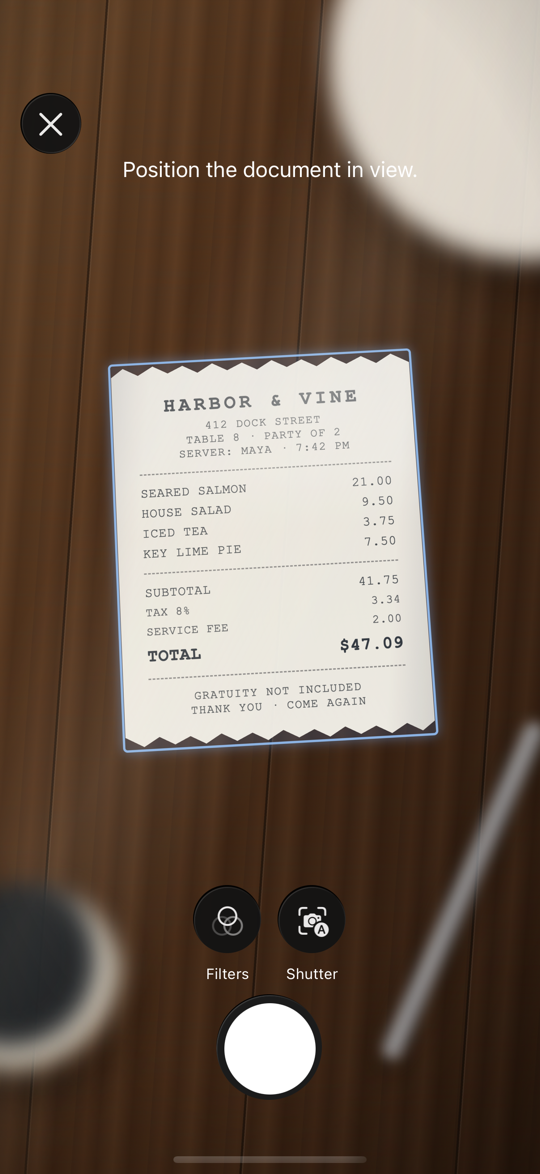 Pitip scanning a paper restaurant receipt with the iPhone camera, reading the total, tax, and service fee